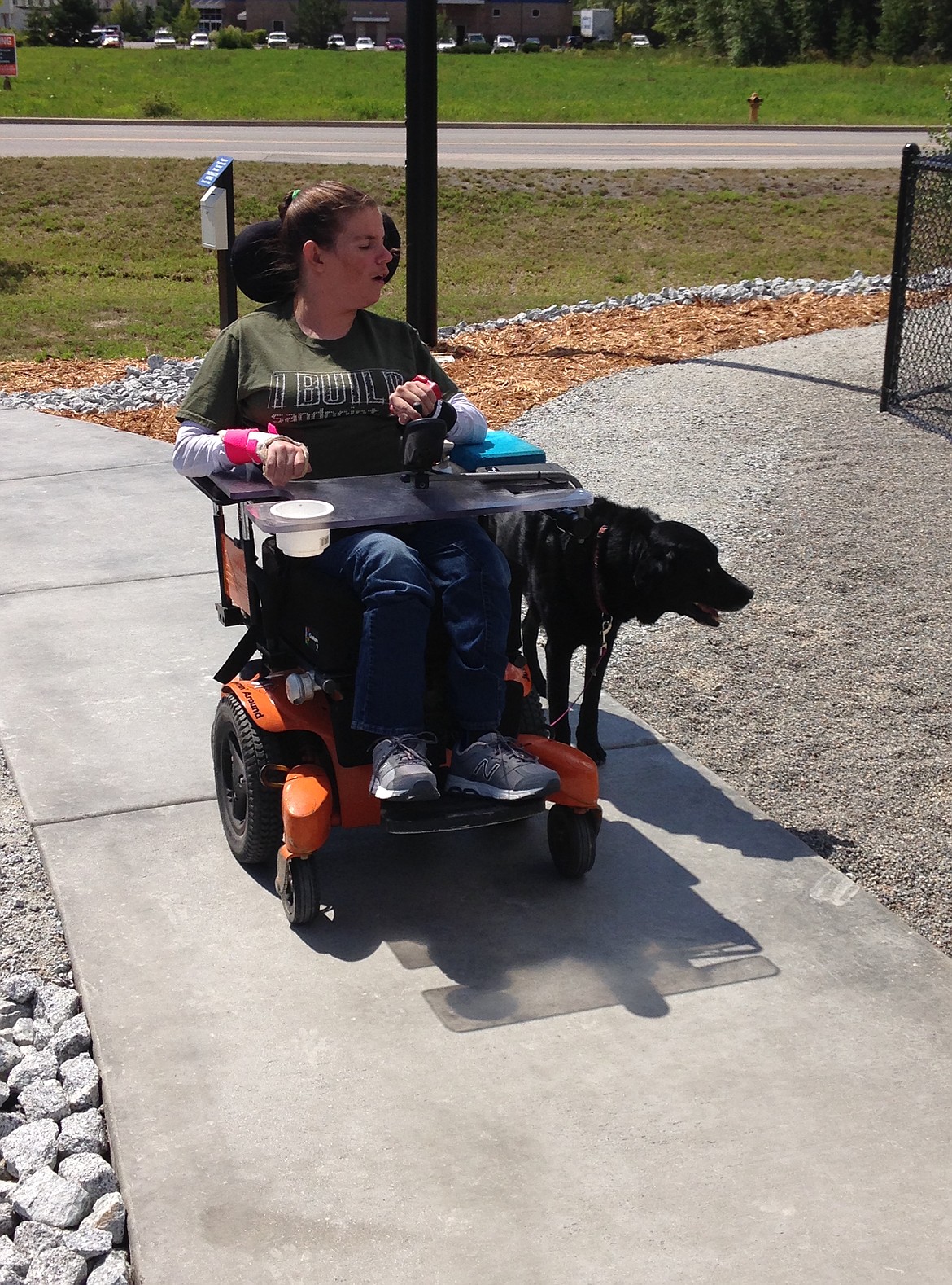 (Photo by MARY MALONE)
Caitlin Bayles navigates her wheelchair up the path of the new Ponderay Dog Park. She and her dog Diesel were the first to try out the ADA accessibility of the park last Thursday.