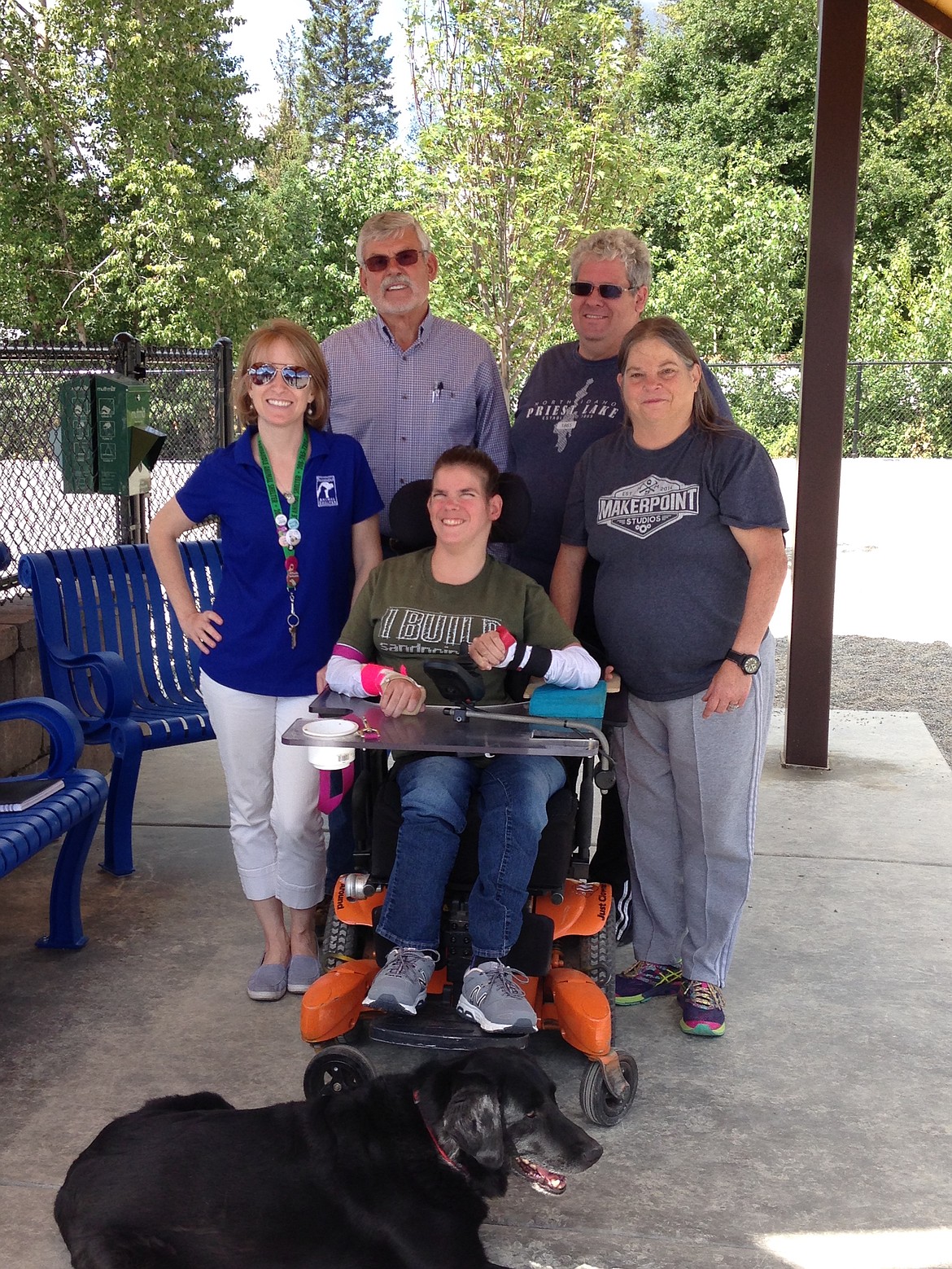 (Photo by MARY MALONE)
Caitlin Bayles, front center, and her dog Diesel were the first to try out the ADA accessibility of the Ponderay Dog Park last week, which is now open for business. Also pictured from left are Panhandle Animal Shelter executive director Mandy Evans, dog park project manager Steve Nybank, and Caitlin&#146;s parents, James and Marie Bayles.