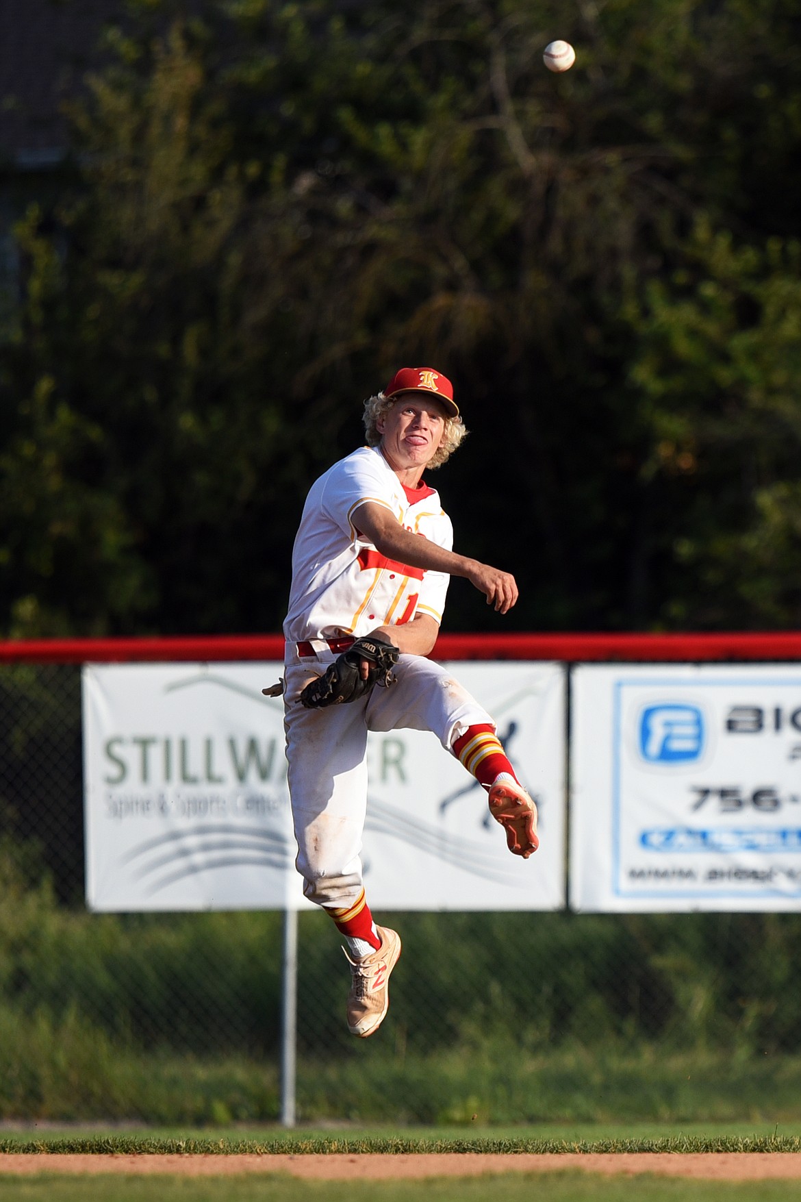 Kalispell Lakers AA shortstop Connor Drish leaps and fires to first after fielding a second-inning grounder hit by Helena Senators AA's Ethan Keinitz at Griffin Field on Saturday. Keinitz was safe at first on the play. (Casey Kreider/Daily Inter Lake)