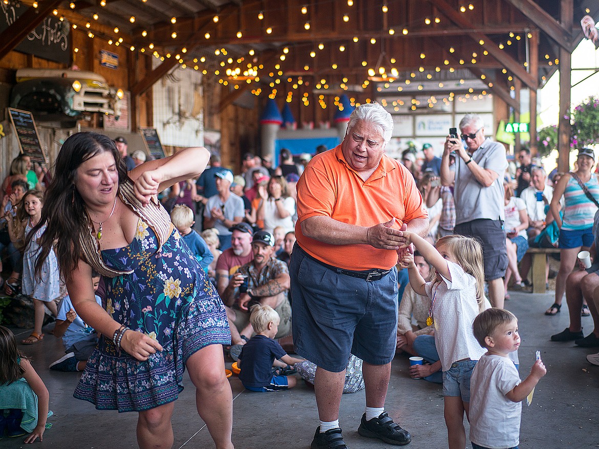 Bob Drolen, right, dances with his granddaughter Ruby Perrigo at the Coop during Heritage Days Thursday.