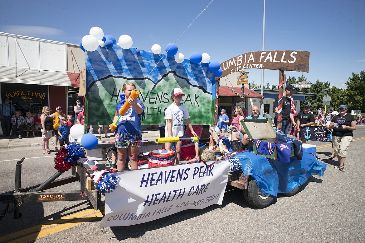 The Heaven&#146;s Peak Healthcare float cools off the crowd.