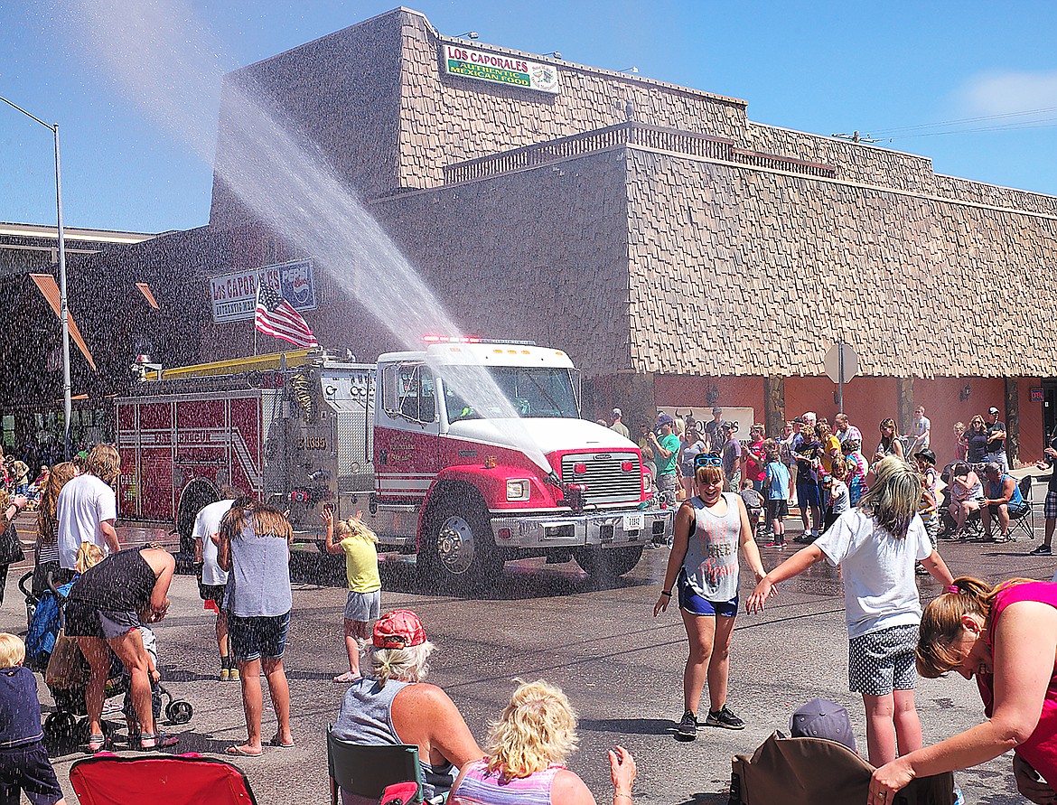 A fire truck cools off the crowd.