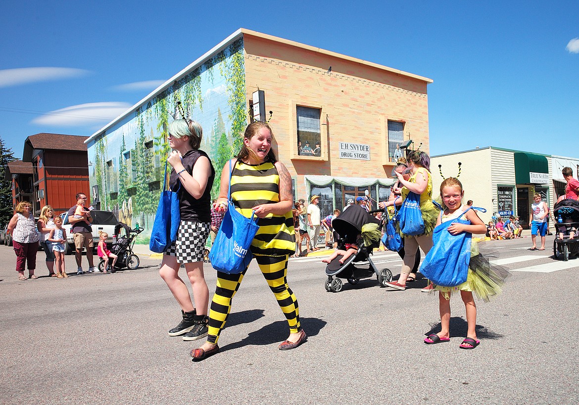 Paisley Wiebelhaus, right, walks in the parade for Bee Hive Homes.