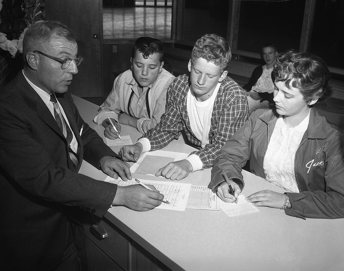 Columbia Falls High School Principal Carl Launer and transfer students Jim Holt, Everett Wash and Virginia Knudsen on the first day of school at the new high school in 1959. (Mel Ruder photo)