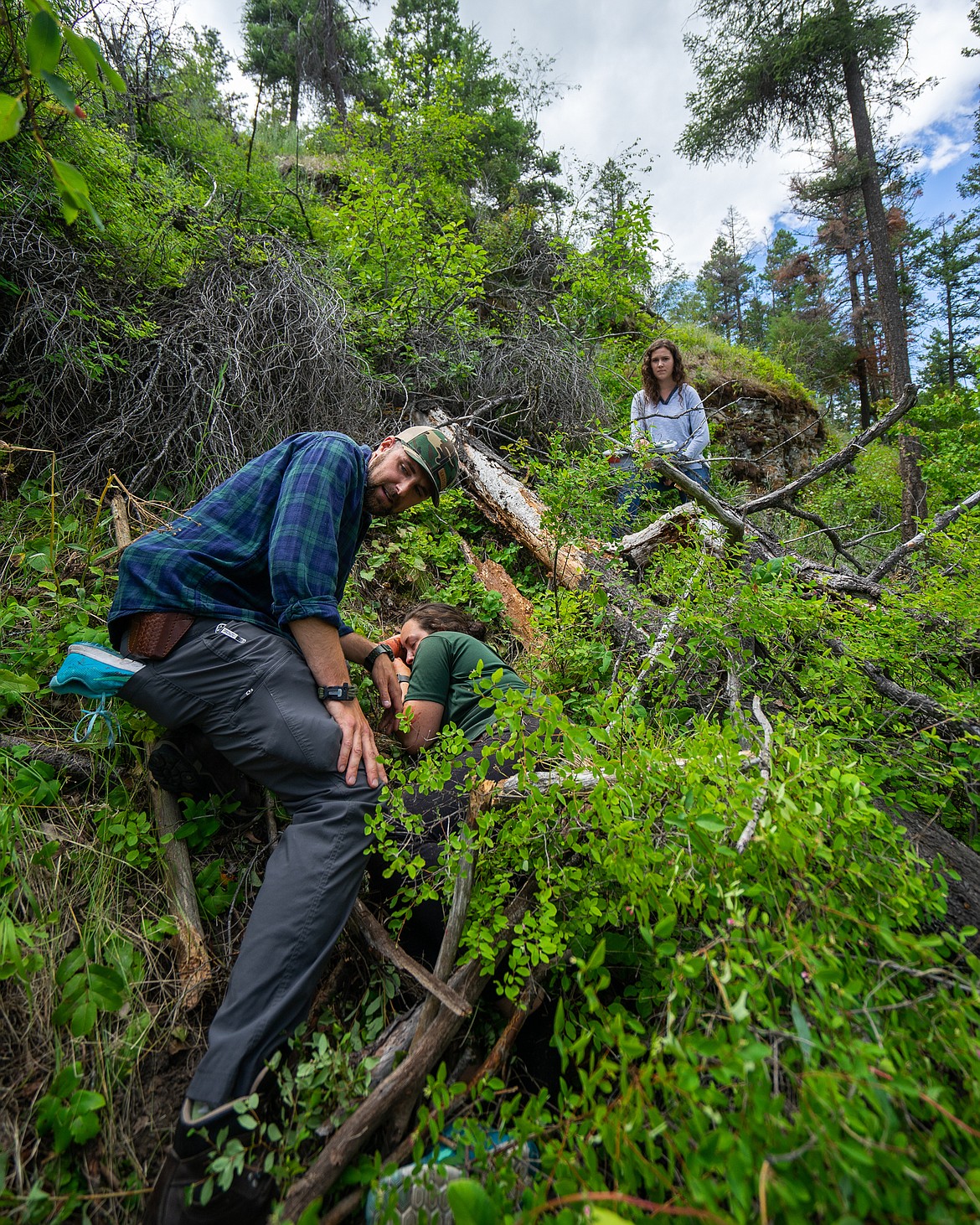 Region 1 Game Warden Justin Slobuszewski tends to a pretend-victim of an animal attack during a Montana Fish, Wildlife and Parks training program. (Daniel McKay/Whitefish Pilot)