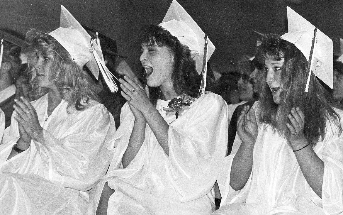 From left, Monica Peterson, Christy Sutter and Helen Schaeffer cheer on classmates during the 1989 Columbia falls High School graduation.