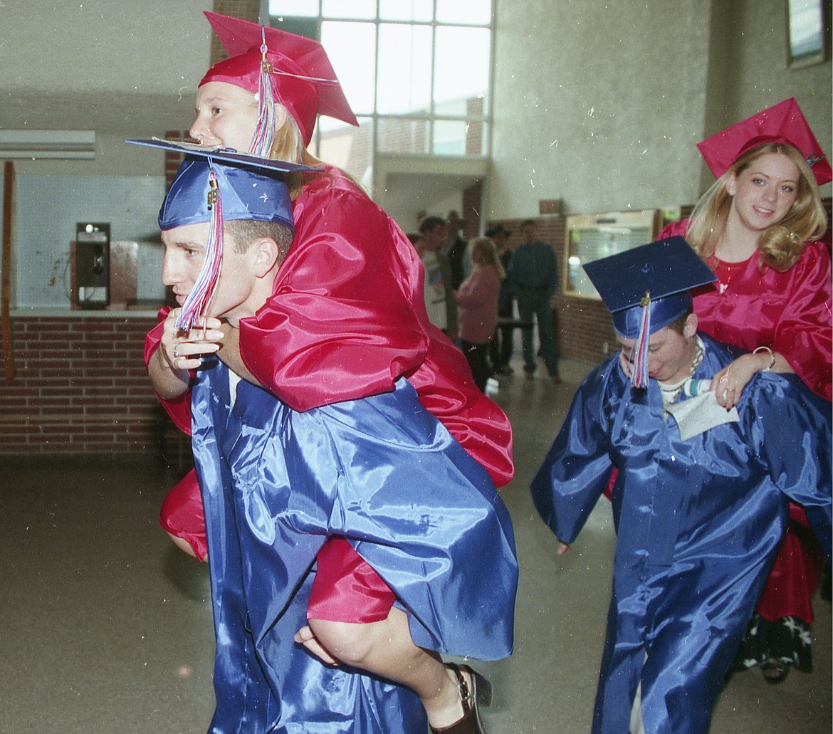 Entering the gym for graduation in 1999 were, from left, Mike Peters, LaNae Adams, Josh Gale and Lynsee Forshee.