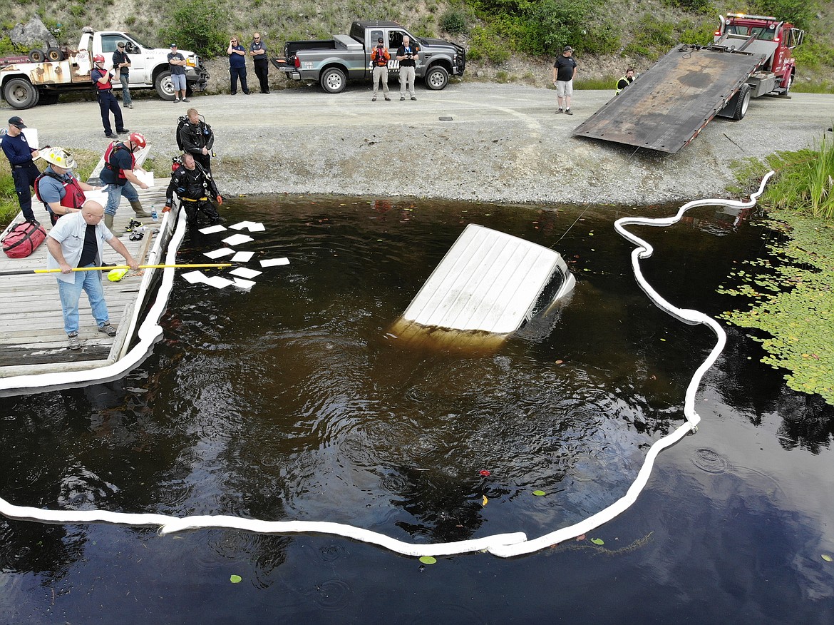 (Courtesy Photo)
The 1989 Toyota Land Cruiser being pulled from Perkins Lake while firefighters provide hazmat operations.