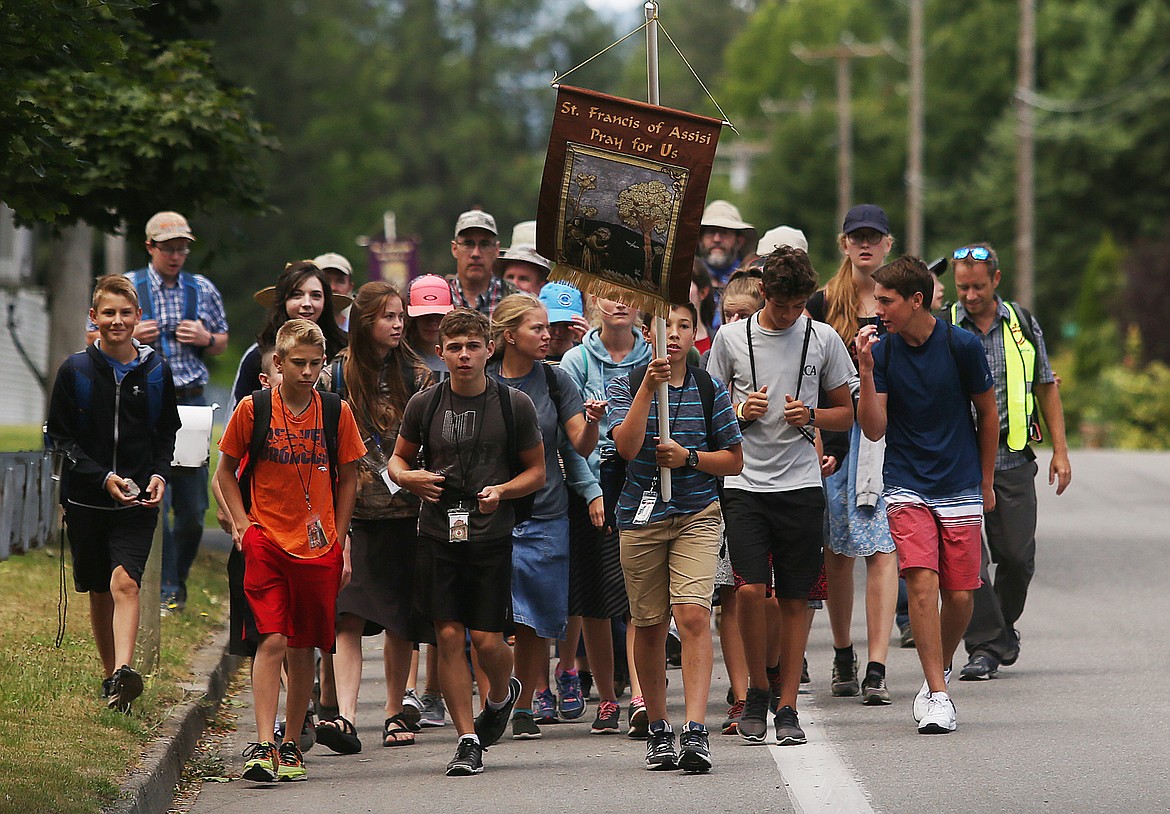 LOREN BENOIT/Press
Catholics from across Kootenai County began their three-day annual pilgrimage Friday to the Catlado Mission this weekend. Here, they walk on East Mullan Avenue to East Coeur d&#146;Alene Lake Drive, where they follow the Centennial Trail to Higgens Point before curving north to make camp north of Wolf Creek Lodge.