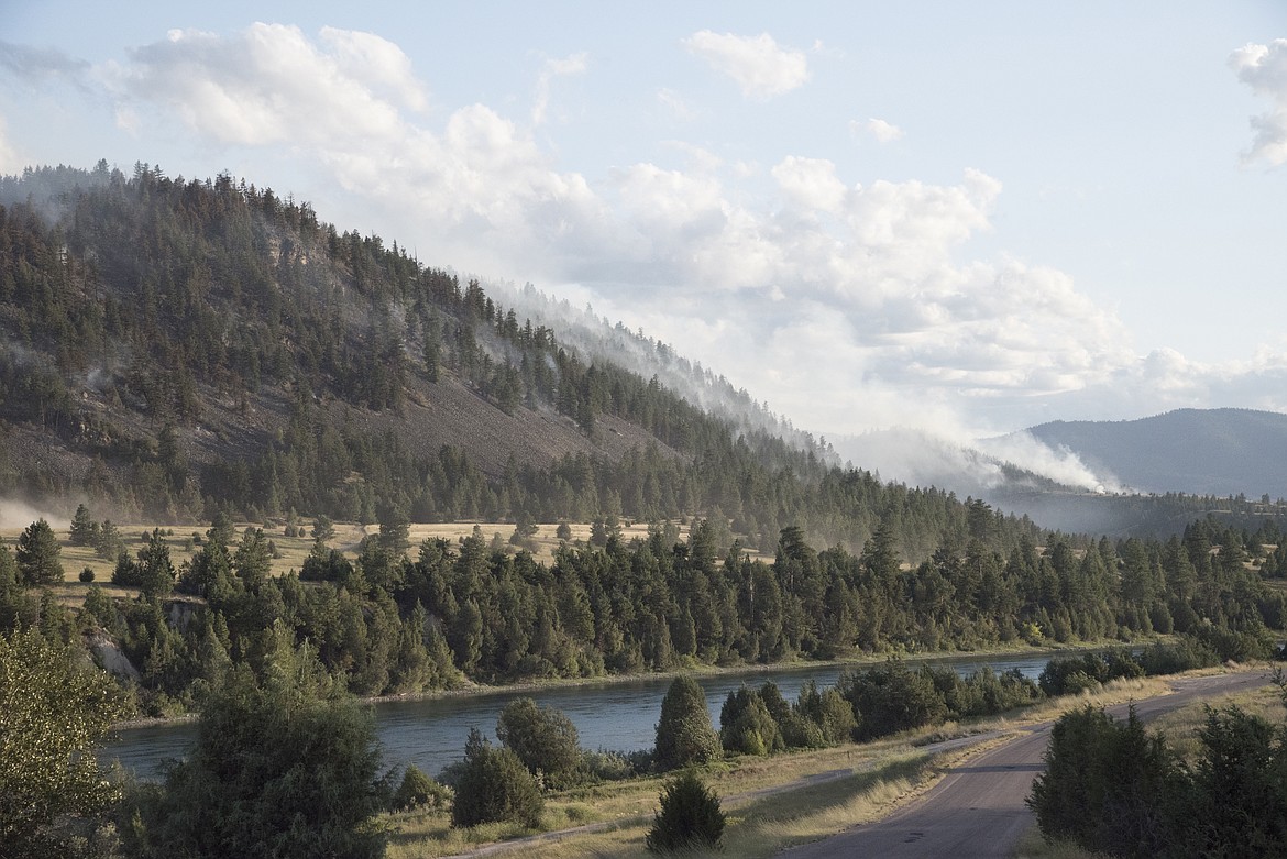 Smoke from the Moss Ranch fire can be seen wafting up the hillside across from the Flathead river near Sloan's bridge southwest of Ronan. (photo by Marla Hall/Lake County Leader)