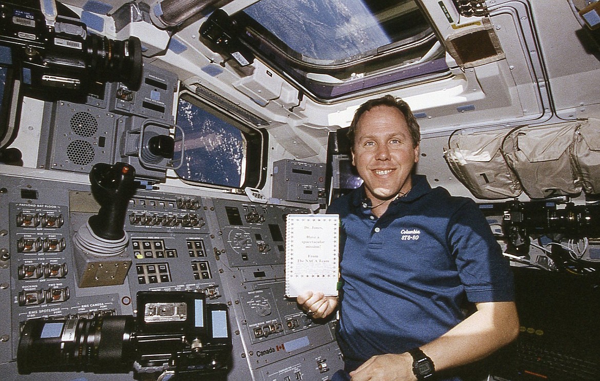 (Photo courtesy NASA and DR. TOM JONES)
Astronaut Dr. Tom Jones displays a good luck letter faxed to him aboard the Space Shuttle Columbia while in orbit from the fifth-grade classroom in Priest River. With each student signing, their names are recorded as having flown in space, demonstrating the influence and love so many American scientists and space explorers share from the inspiration instilled in them by the students of this small American town.