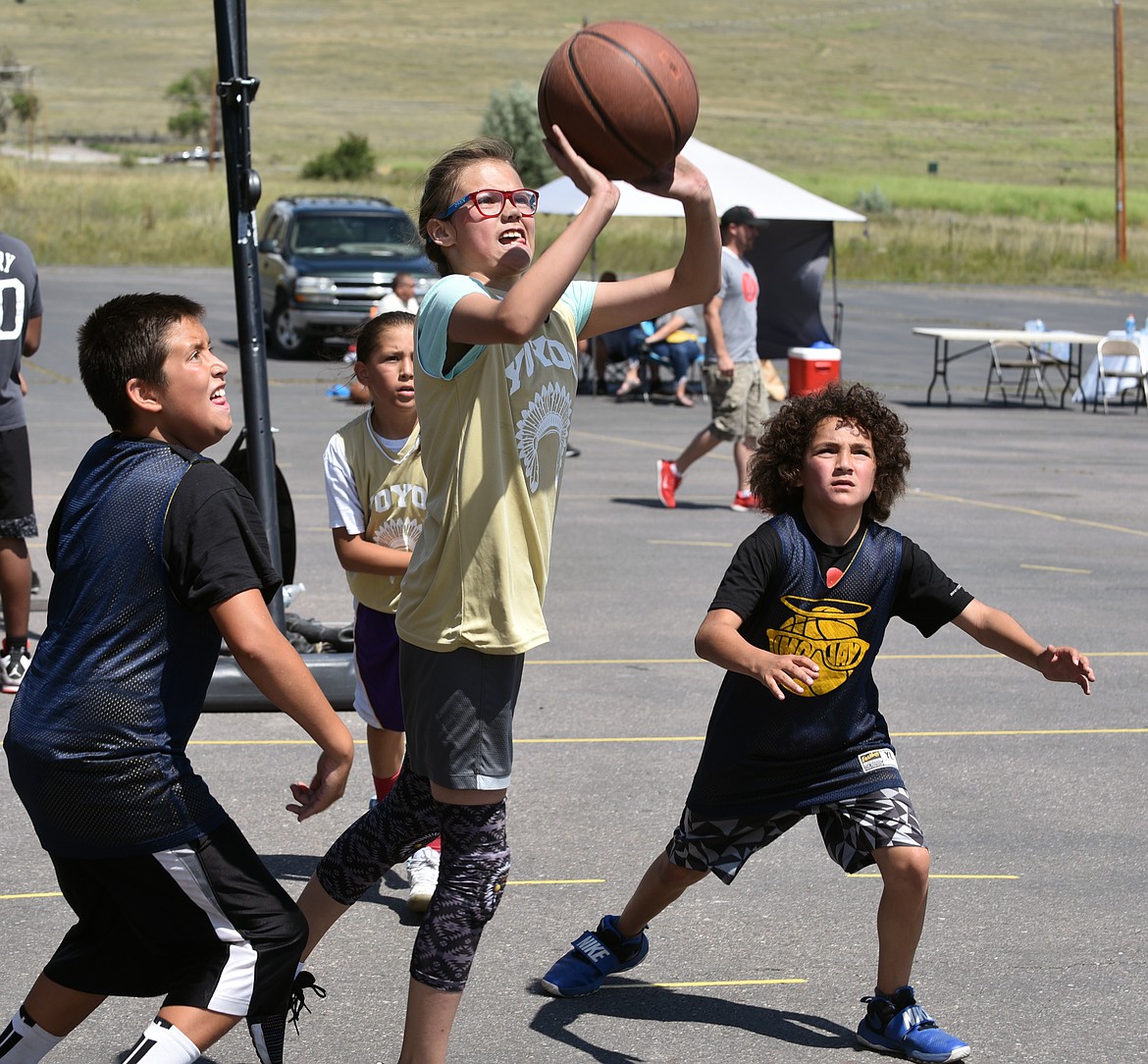 AN ELMO 3-on-3 contestant attempts a jump shot during the later portion of the 3-on-3 basketball tournament Saturday afternoon in Elmo. This is the third-consecutive season Elmo has hosted the 3-on-3 basketball tournament. (photo by Jason Blasco/Lake County Leader)