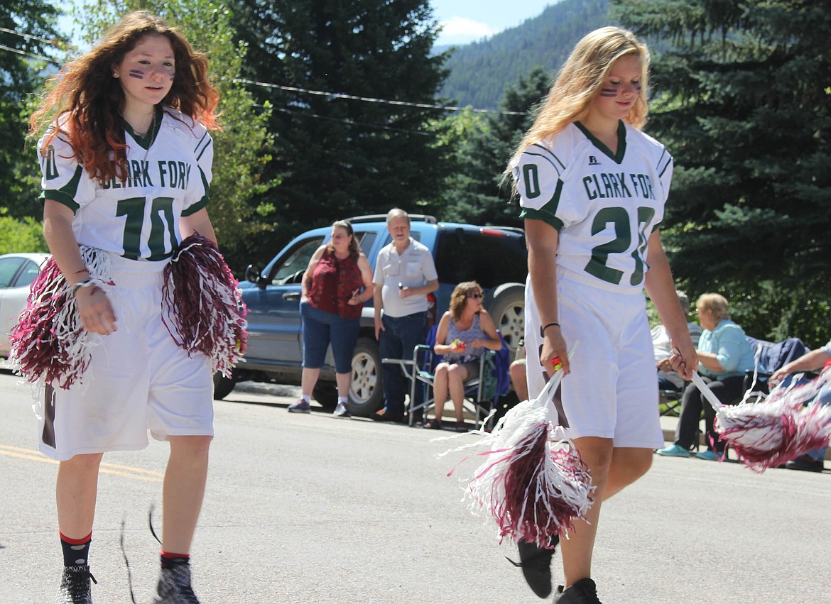 Alberton eighth-grader Lynette Nix and freshman Violet Claxton walk in the Railroad Days parade in Alberton. (Maggie Dresser/Mineral Independent)