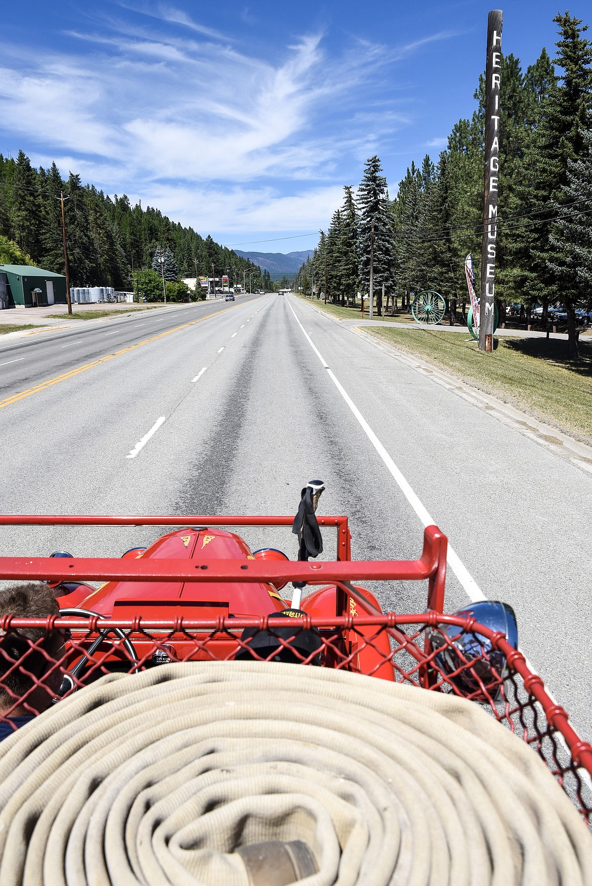 A vintage fire engine from the Libby Volunteer Fire Department heads up Highway 2 back to the Heritage Museum, with LVFD firefighter Dan Davis at the wheel, Sunday at the annual Libby Pioneer Society Picnic. (Ben Kibbey/The Western News)
