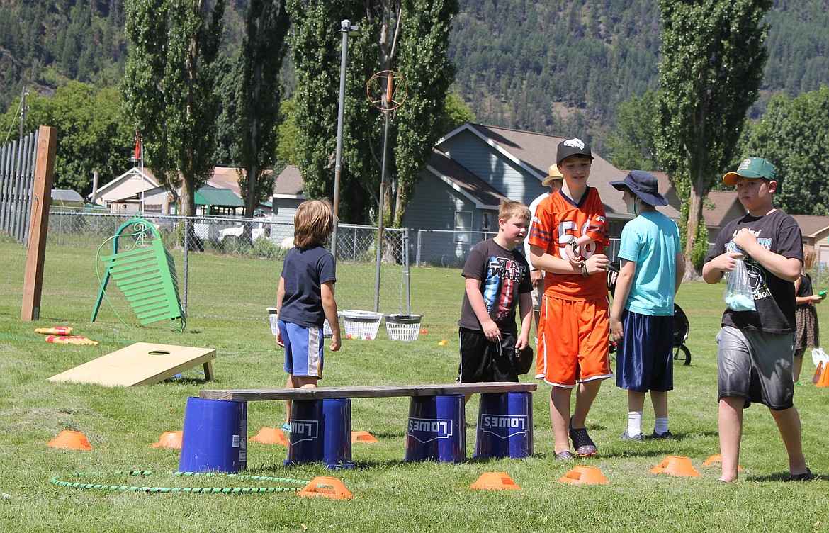 Kids play games set up in the Hank Roat Memorial Park at Railroad Days. (Maggie Dresser/Mineral Independent)