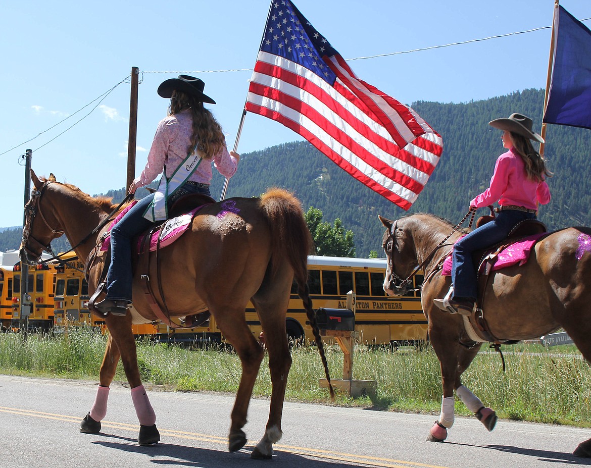 Rodeo Queen Emma Hill and Rodeo Princess Darby Haskins ride in the parade on Saturday, July 20. (Maggie Dresser/Mineral Independent)