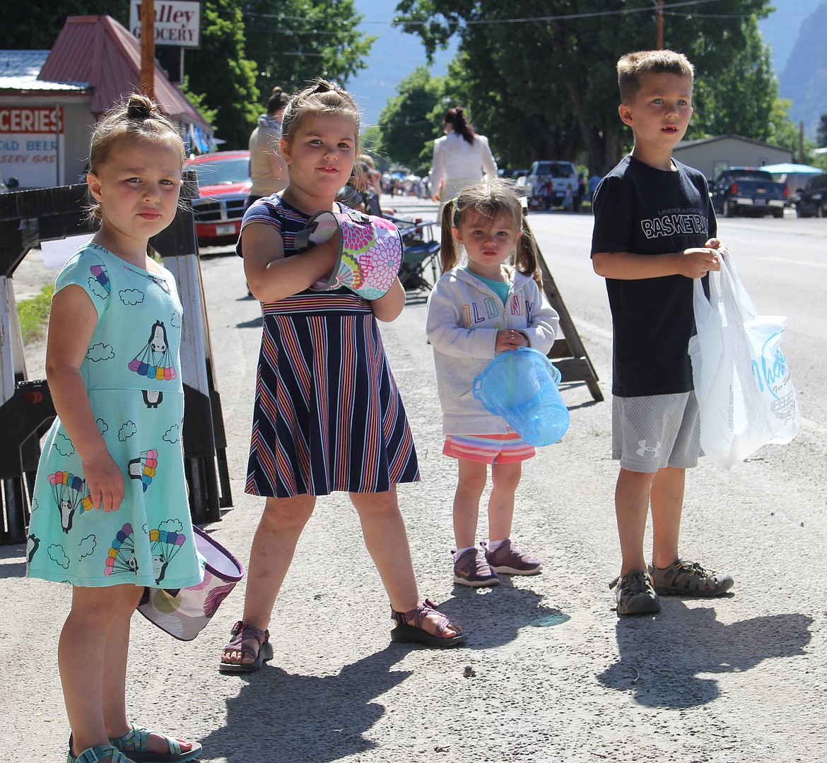 Camryn Gardner, Caitlyn Gardner, Ryleigh Nagy and Cason Gardner watch the parade and wait for candy to be thrown. (Maggie Dresser/Mineral Independent)