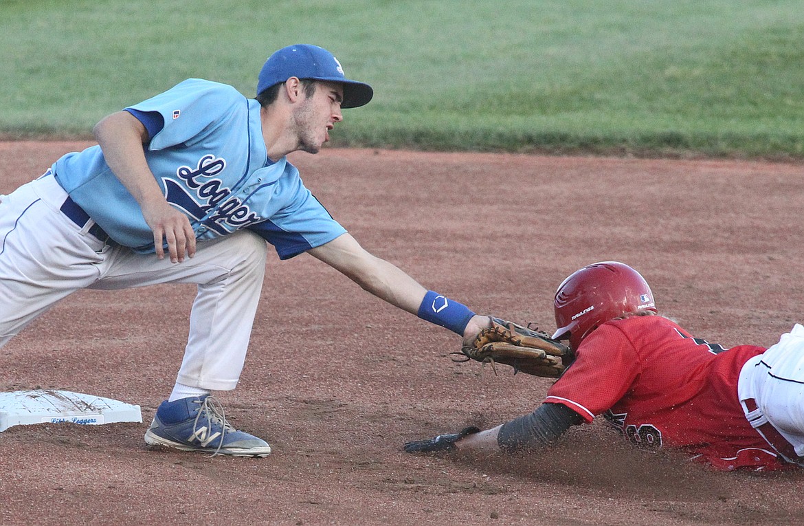 Shortstop Jeff Offenbecher puts the tag on Greg Rebagliati for the third out bottom of first inning vs. Bandits July 18. (Paul Sievers/The Western News)
