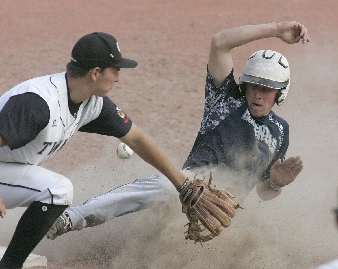 Eric Dolence slides safely to third on a Twins error top of seventh inning with one out. Third baseman is Jack Schwaiger. (Paul Sievers/The Western News)