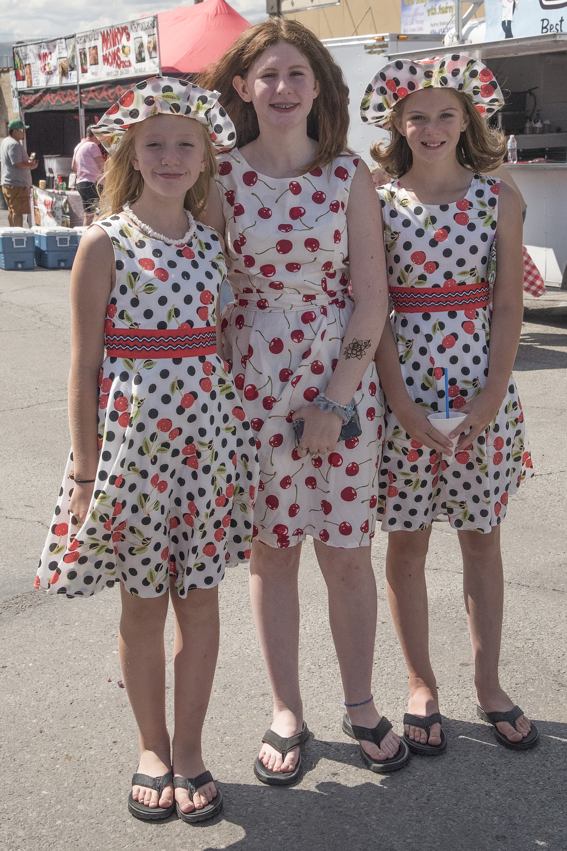 Cousins McKenna Kreis, Hamony Schilling and Alison Putzler are dressed for the Polson Cherry Festival. The 12-year-olds  from Frenchtown and Kalispell have a special weekend with their grandparents every summer and plan it so that they can attend the cherry festival.