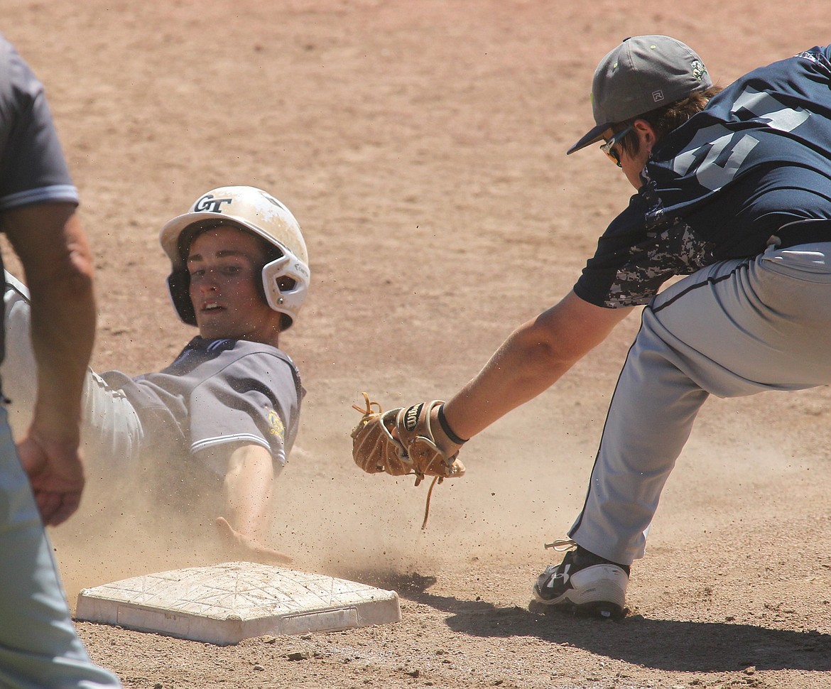 Jack Price slides safely into third base in the West A District Tournament last weekend in Libby. (Paul Sievers photo)