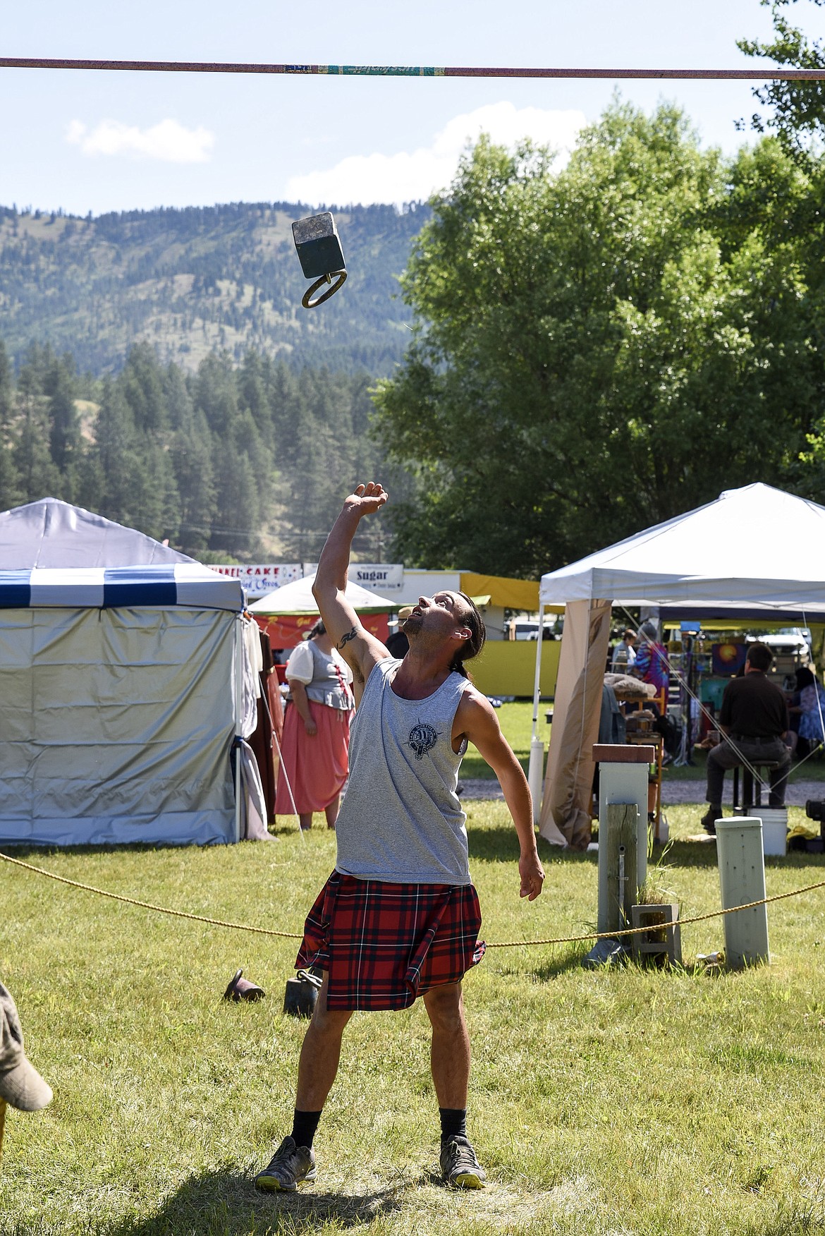 Jeremy Nelson, from Bonners Ferry, competes in the weigh-over-bar, Saturday at the Kootenai Highland Gathering and Celtic Games. (Ben Kibbey/The Western News)