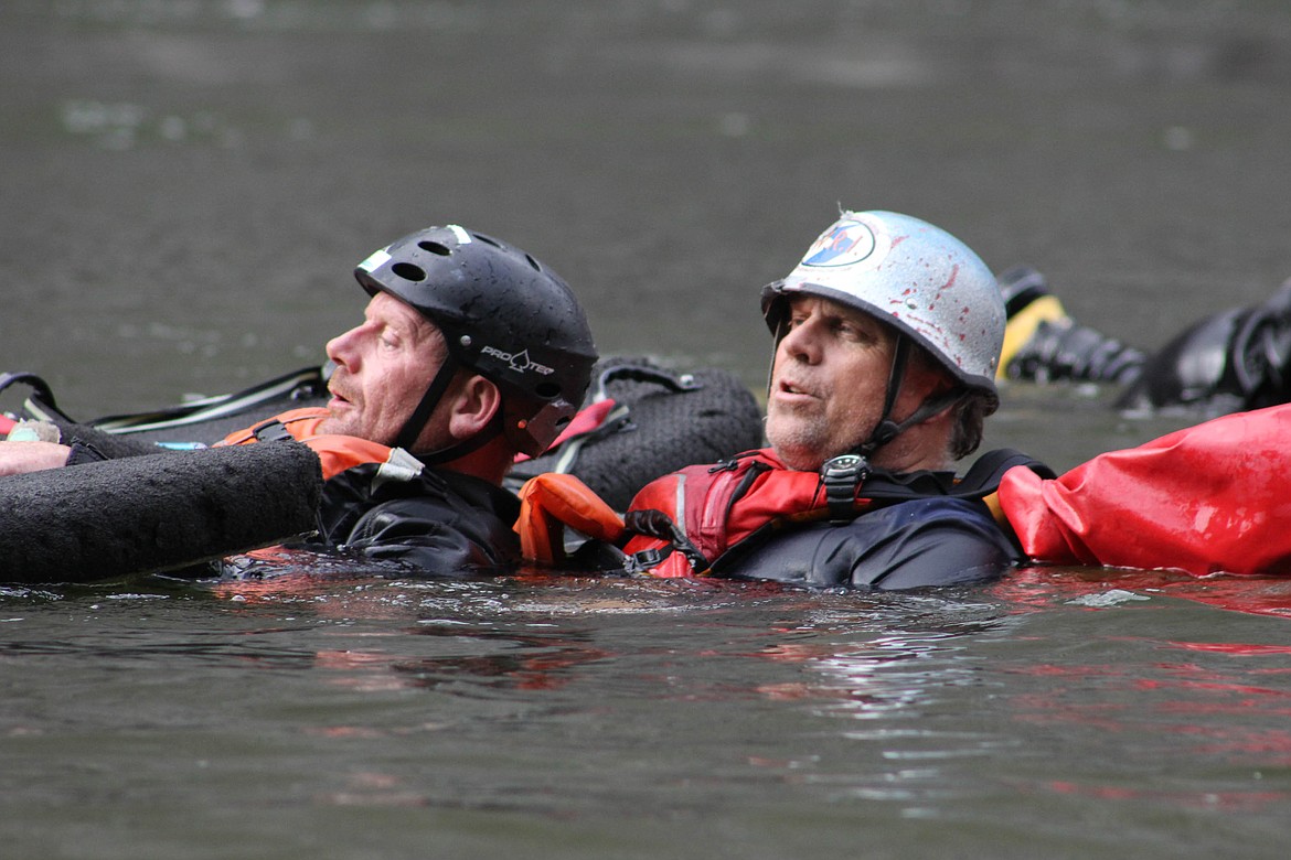 Montana River Guides owner Mike Johnson teaches veteran Thomas Bond safety skills before river boarding. (Maggie Dresser/Mineral Independent)