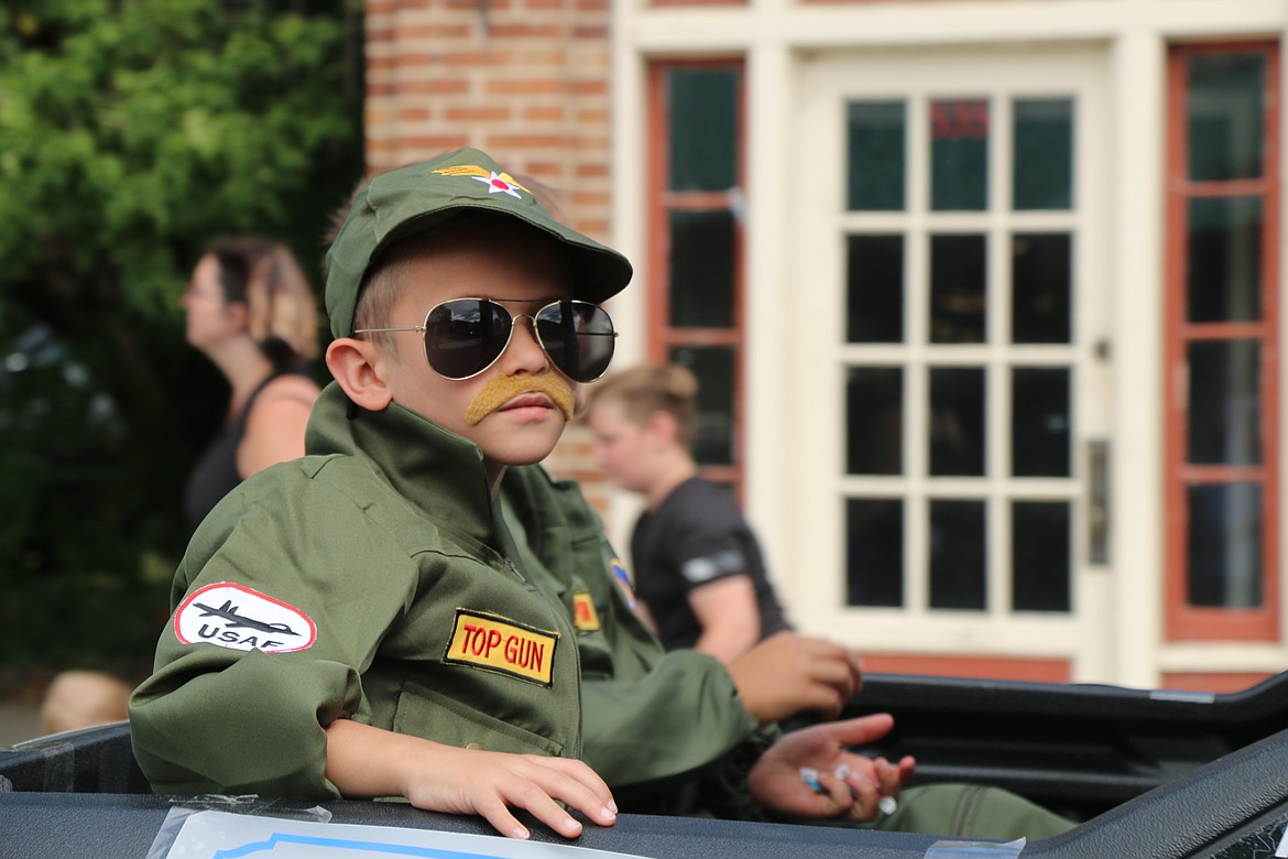 (Photo by CAROLINE LOBSINGER)
A youngster pays homage to the military as he takes part in the annual Priest River Timber Days parade.