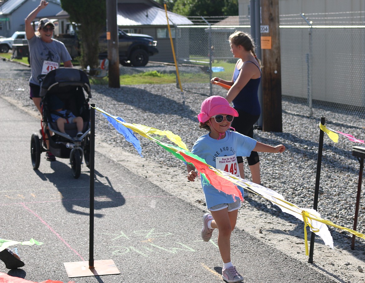 (Photo by MARY MALONE)
A youngster crosses the finish in the 1 mile Run for the Berries race in Priest River on Saturday.