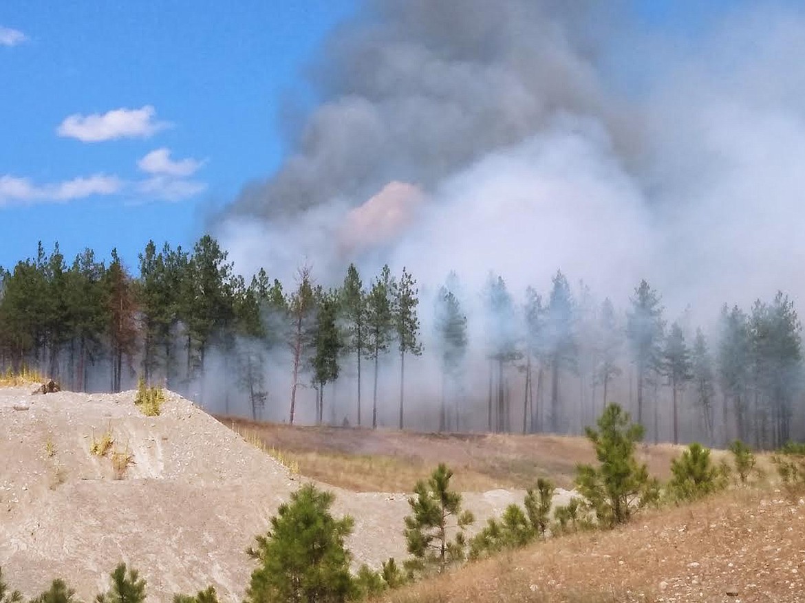 SMOKE POURS from a wildfire Tuesday afternoon near the U.S. Forest Service fire cache located off of Pipe Creek Road outside of Libby. (Suzanne Resch/The Western News)