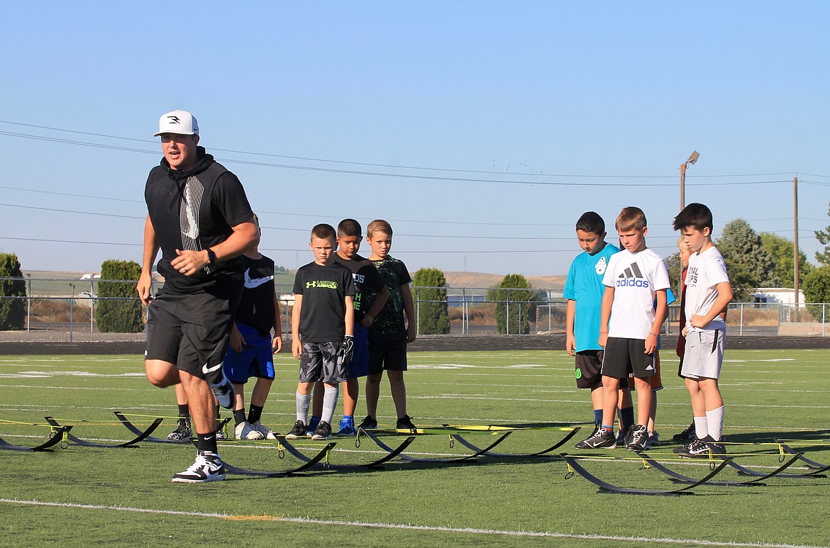 Casey McCarthy/Sun Tribune
Jake Heaps leads third to eighth graders in drills as part of the Russell Wilson Quarterback Academy.