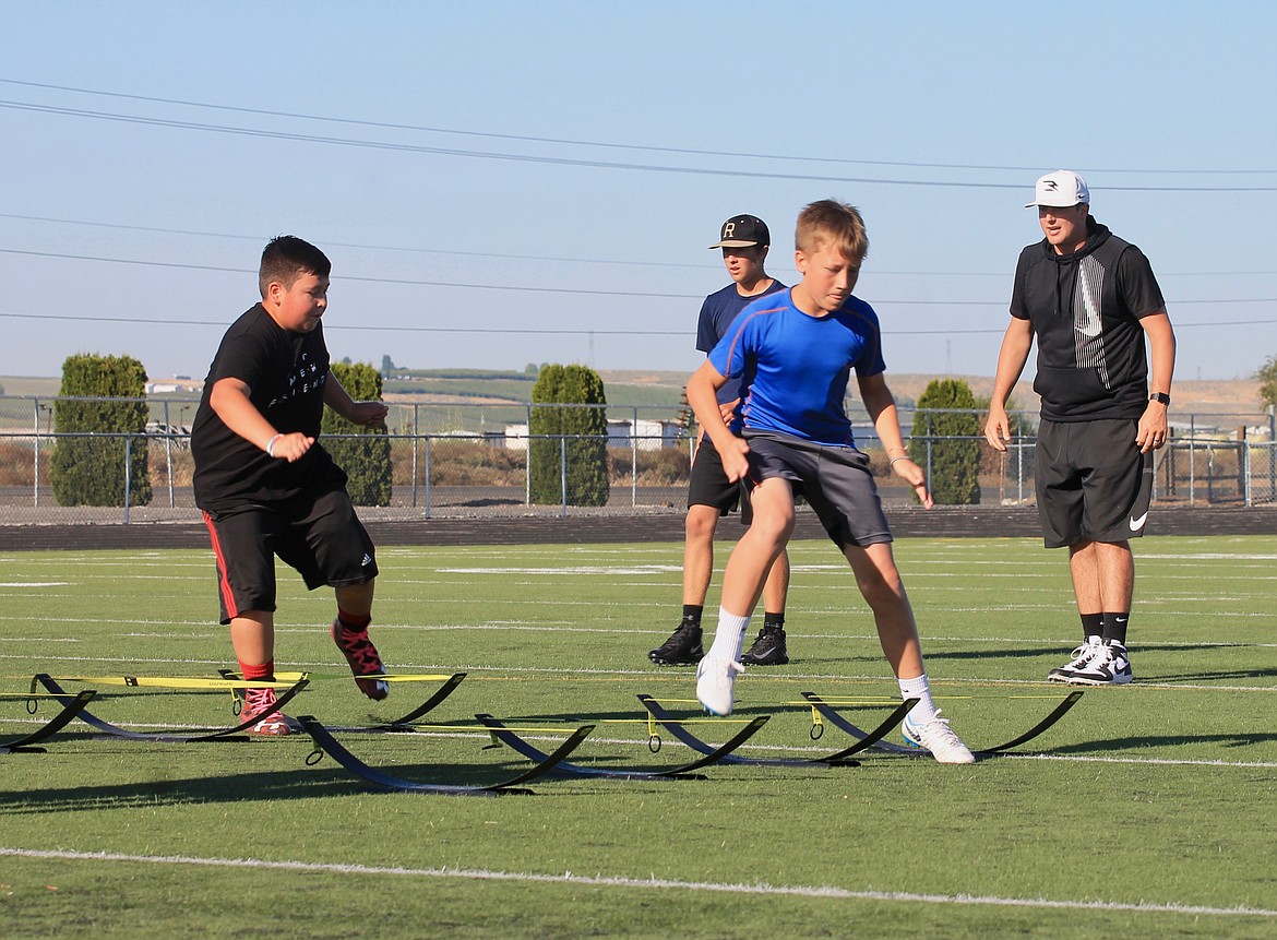 Casey McCarthy/Sun Tribune
Third to eighth graders work on their fundamentals at the two-day football camp.