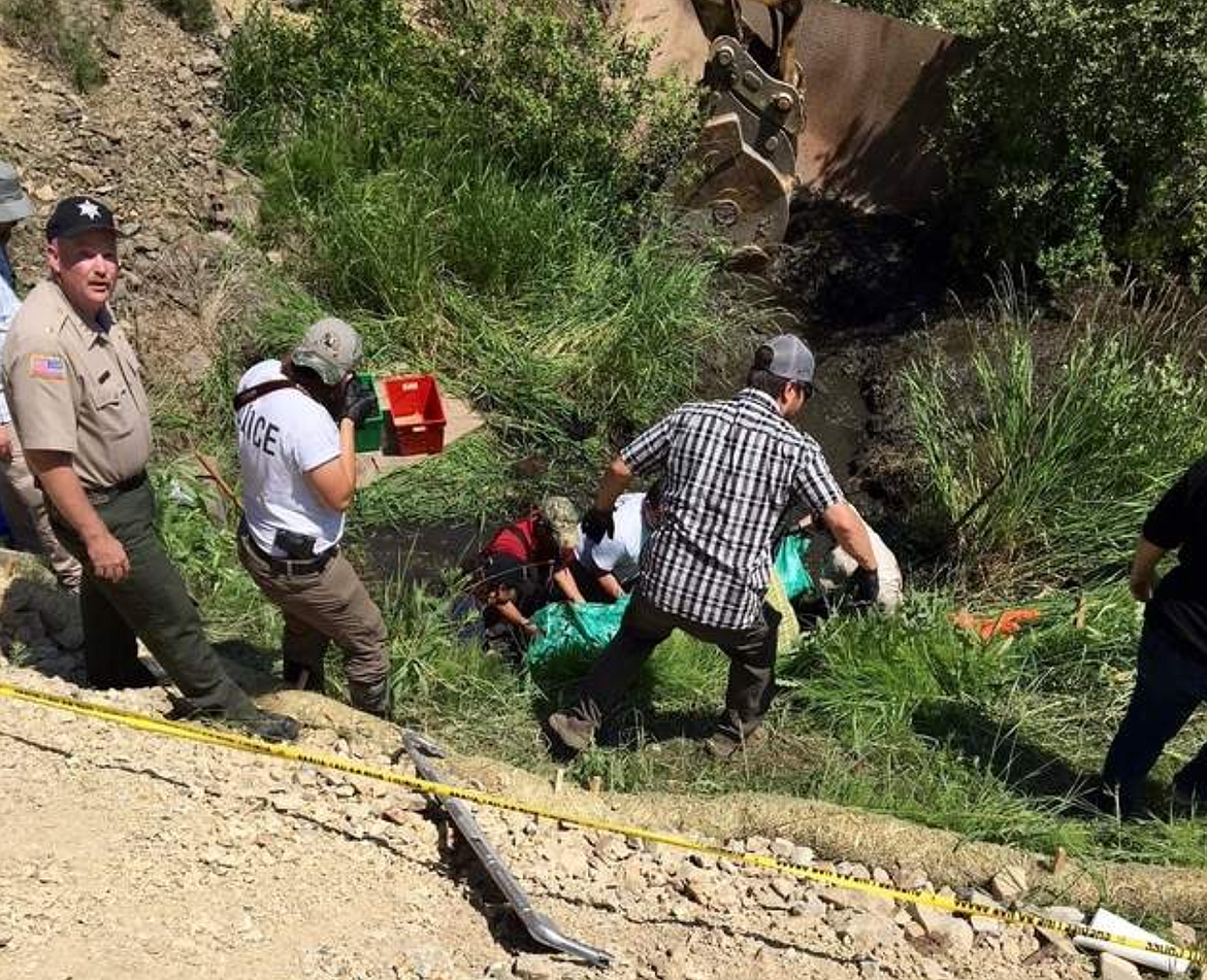 Photo by IDAHO STATE POLICEShoshone County Sheriff Mike Gunderson (left) supervises the recovery effort of the remains by Idaho State Police detectives last year in Kingston.