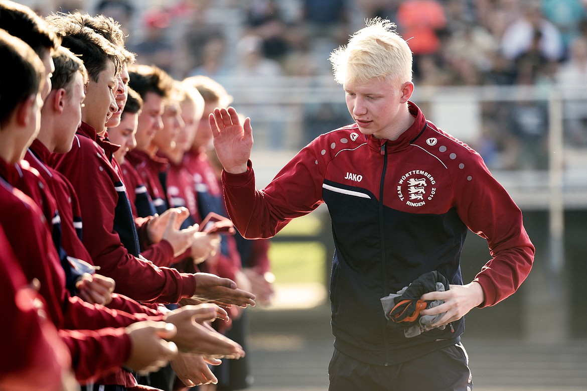 Baden-W&uuml;rttemberg&#146;s Lorenz R&ouml;mpp high-fives his teammates before the start of an annual cultural exchange wrestling exhibition against Flathead Valley wrestlers at Legends Stadium on Wednesday. (Casey Kreider/Daily Inter Lake)