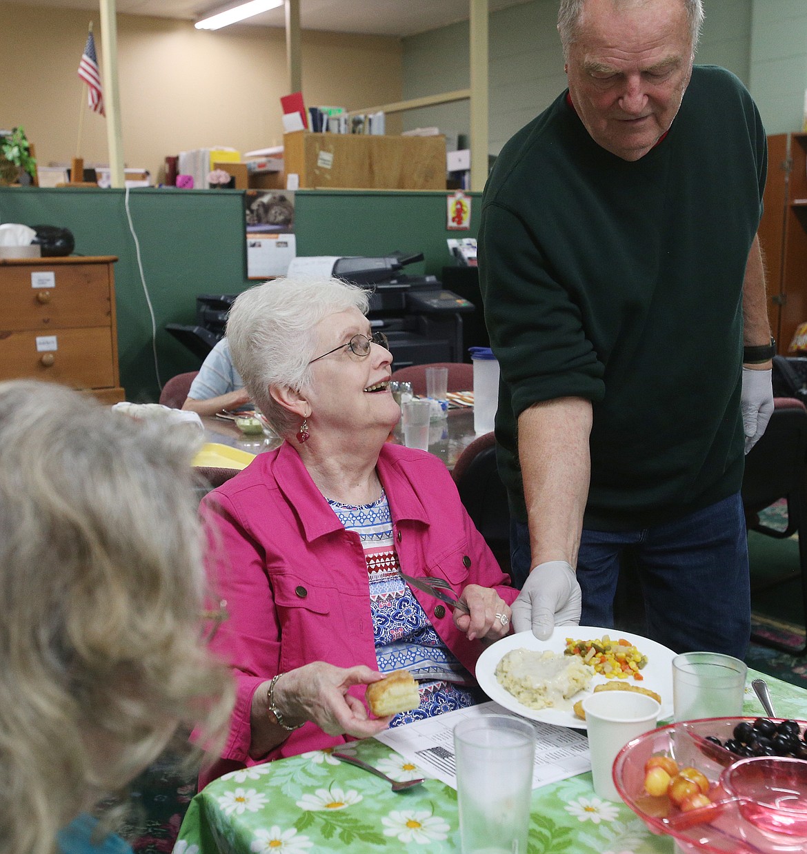 Bob Oz serves Carolyn Weisenburger mashed potatoes, veggies, and baked cod for lunch Thursday, June 27, 2019 at Hayden Senior Center. (LOREN BENOIT/Press)