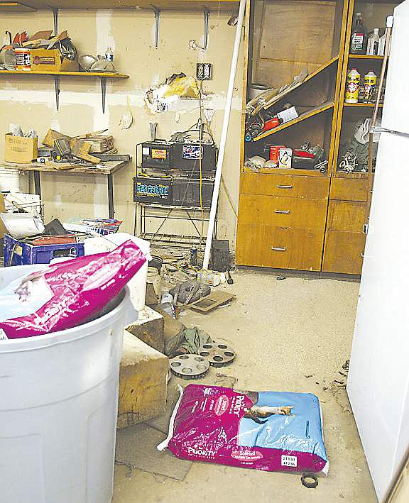 File photoThe inside of Bill Walker's home following his death at the hands of an unknown bomber in 2008. The family was told to put down cat litter to absorb the blood, they said.