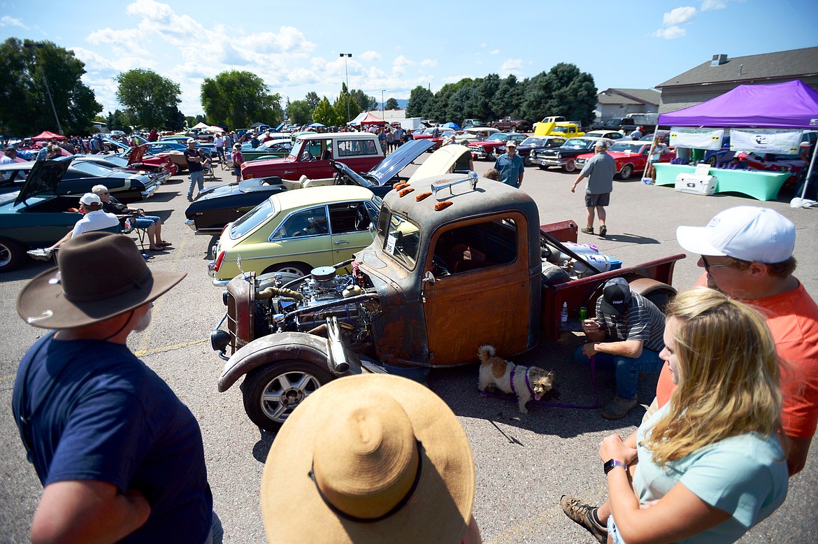 Visitors check out a 1927 White Motor Company 15-B truck at the Evergreen Show &#145;n Shine at Conlin&#146;s Furniture in Evergreen on Saturday. (Casey Kreider/Daily Inter Lake)