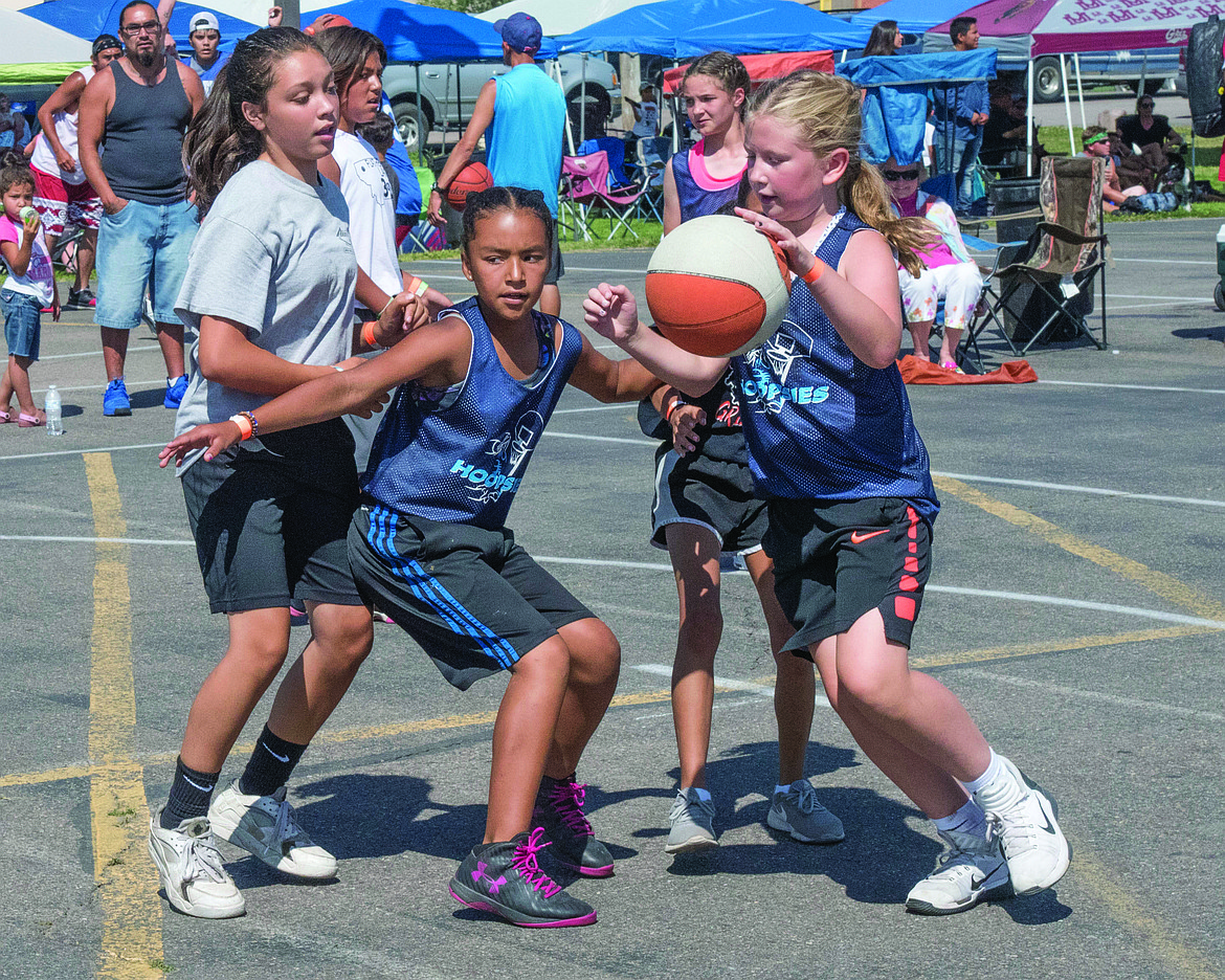 Angel Finley blocks Brook Tanner as teammate Ava Lawyer makes her way to the basket. (photo by Marla Hall/Lake County Leader)