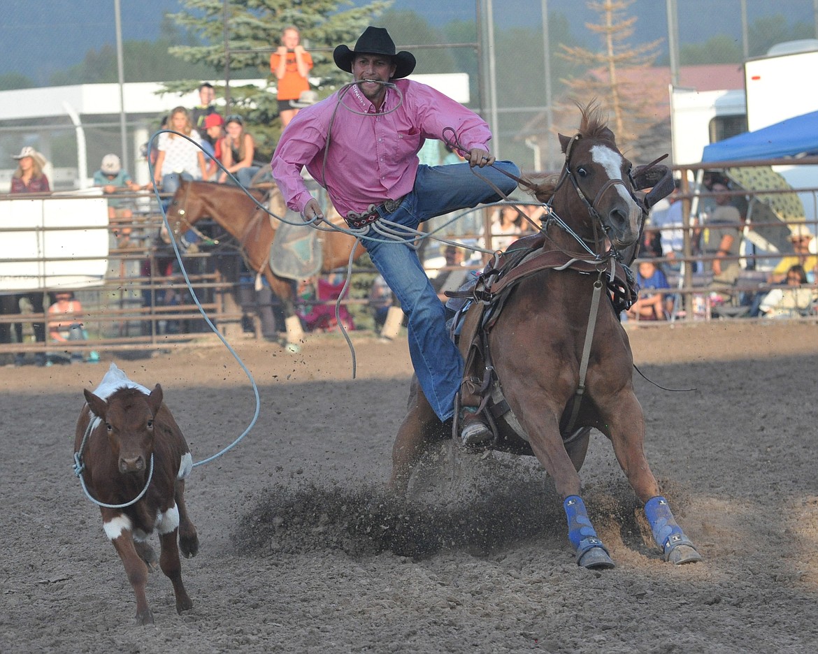 Zanen Pitts steps off his roping horse on his way to throwing the calf and tying it down during the Tie-down calf-roping on Saturday night.  Zanen roped and tied down his calf in 13.8 seconds.