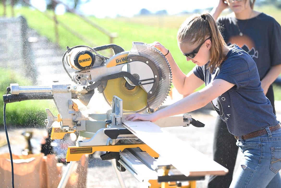 Elena Wrobel of Richmond, Virginia sawing boards. Wrobel is one of the student interns at 100 Fold Studio.