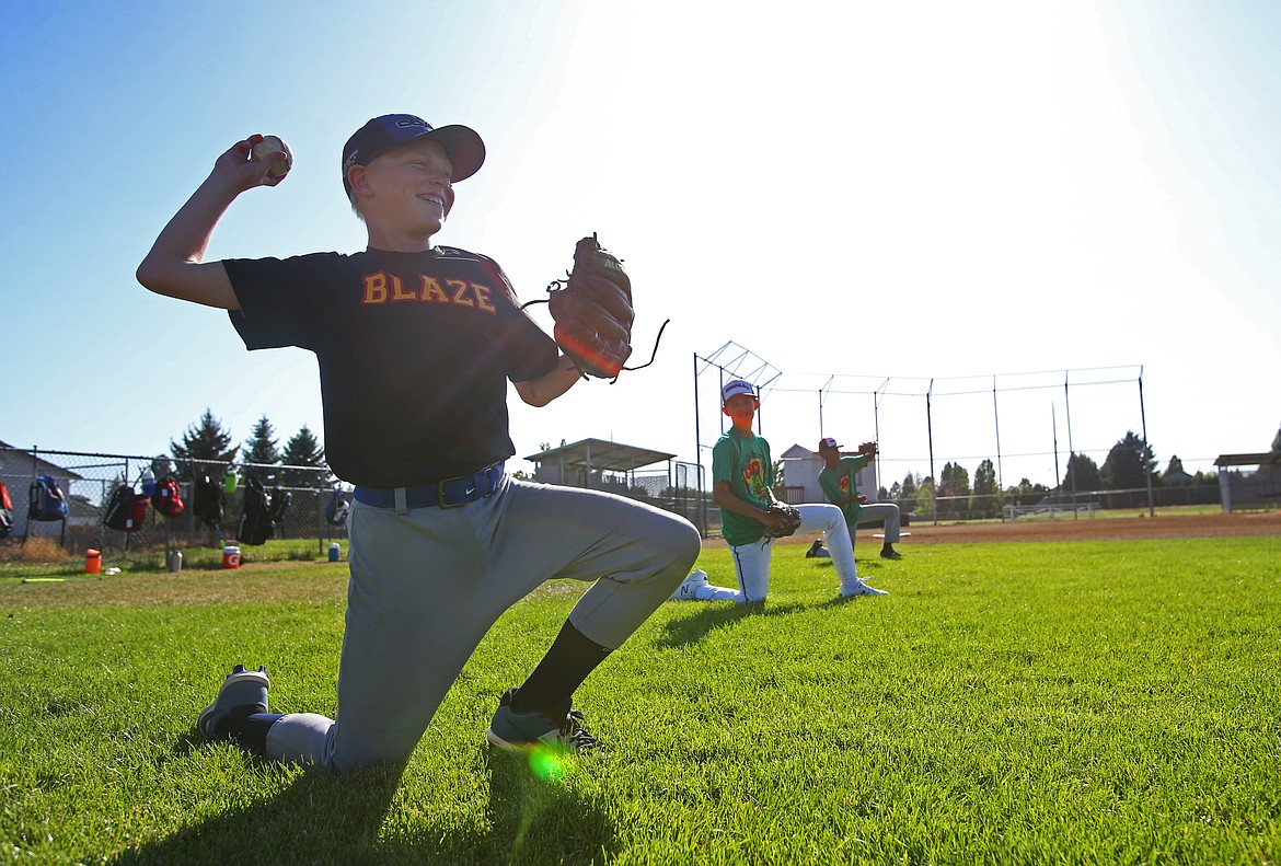 LOREN BENOIT/Press
Tyler Voorhees plays catch with a teammate during practice Tuesday at Canfield Sports Complex.