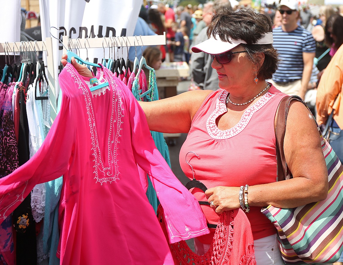 Angela Sieverding shops for a top at the Grace and Joy Clothing booth at the Downtown Street Fair in 2018. (LOREN BENOIT/Press File)