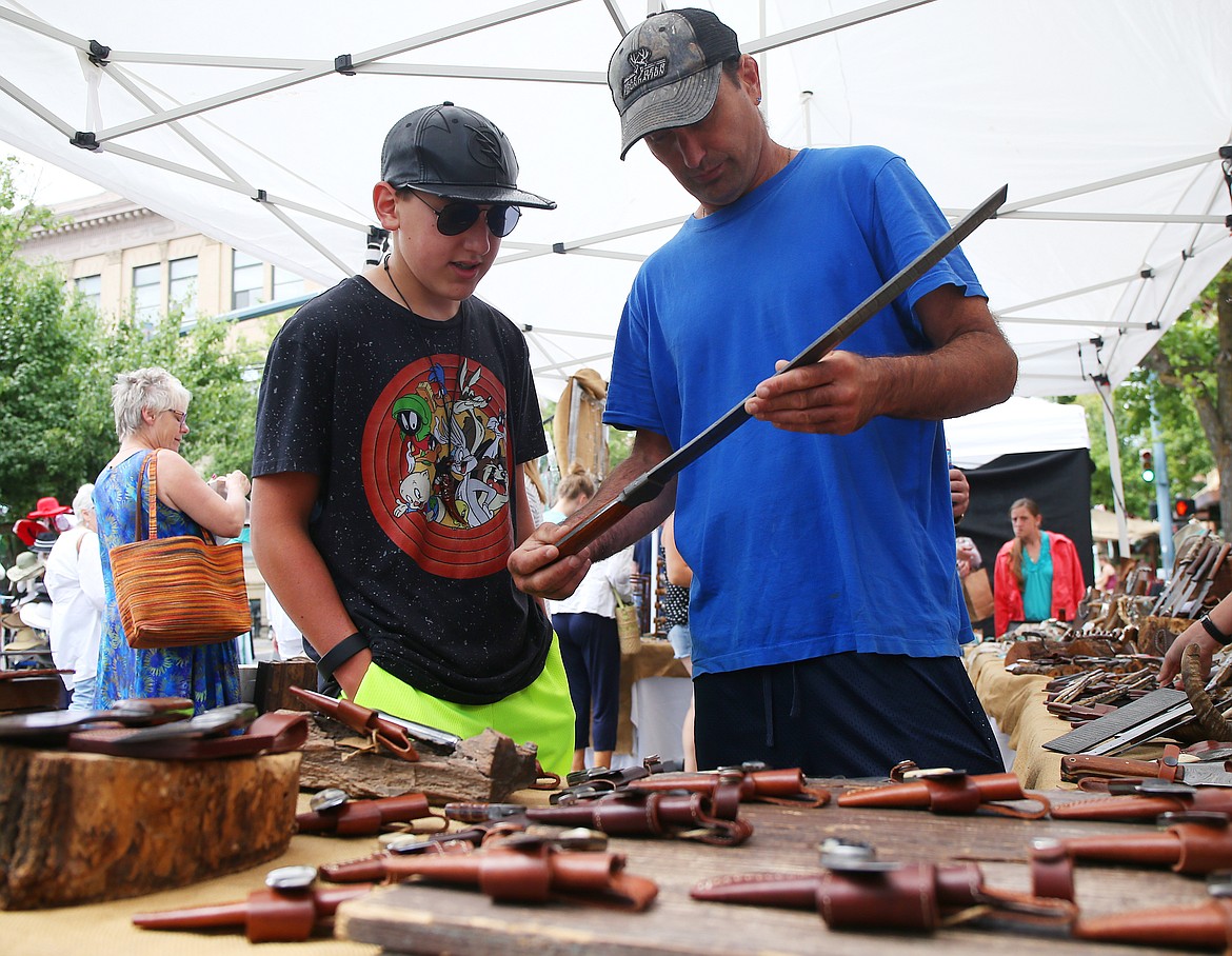 Hunter Magistrale, left, and Daniel Magistrale look at a small sword at the Knives and Wives at Coeur d'Alene's Downtown Street Fair in 2018. (LOREN BENOIT/Press File)