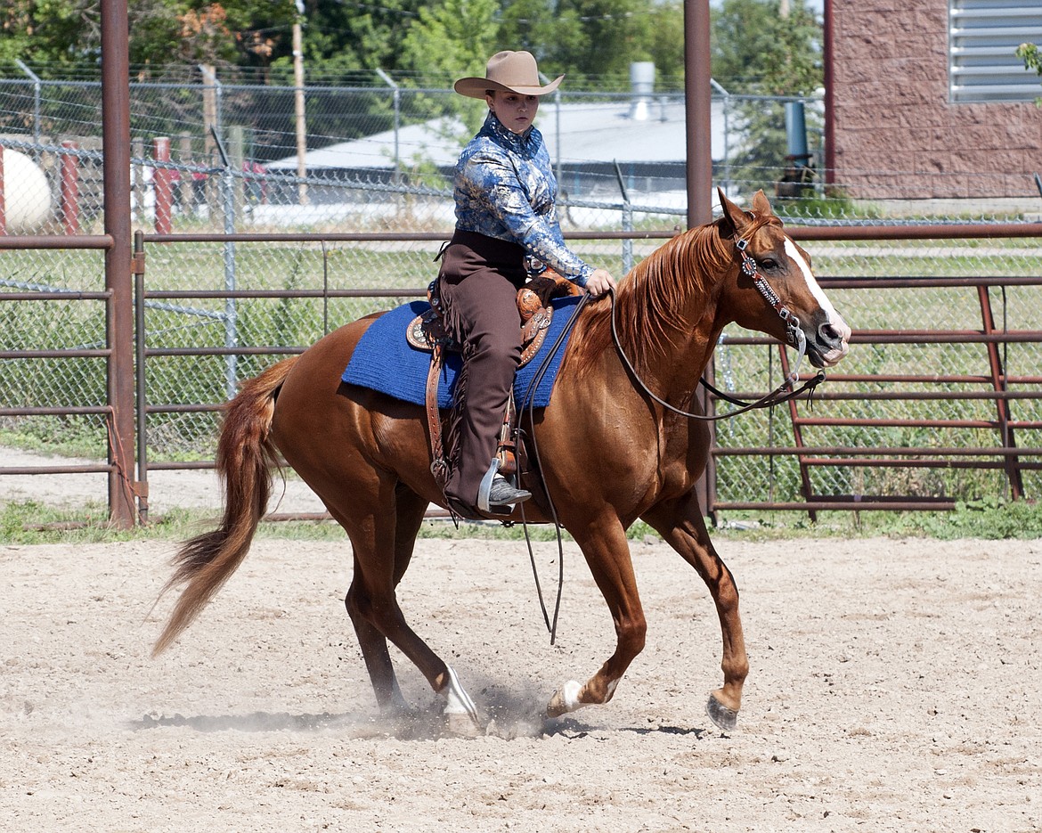 Kyia Hendrickson warms up her beautiful sorrel prior to the riding events at the 4-H Horse show. The pair went on to win several Grand Champion awards.