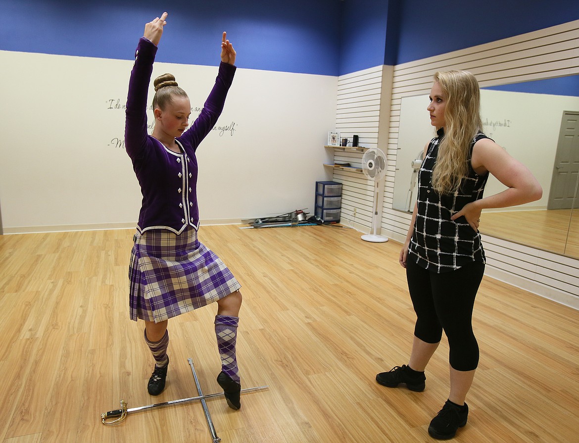 Lake City Highland Dance Studio owner and instructor Kasey Settle inspects Victoria Hawkins' arm form during a practice in the studio Wednedsay morning. (DEVIN WEEKS/Press)