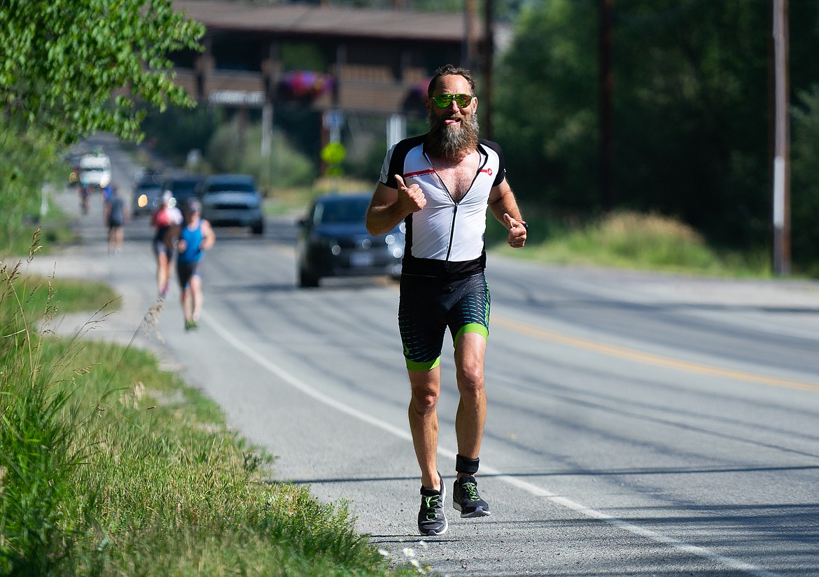 A racer gives the thumbs-up during the Whitefish Lake Triathlon on Sunday. (Daniel McKay/Whitefish Pilot)