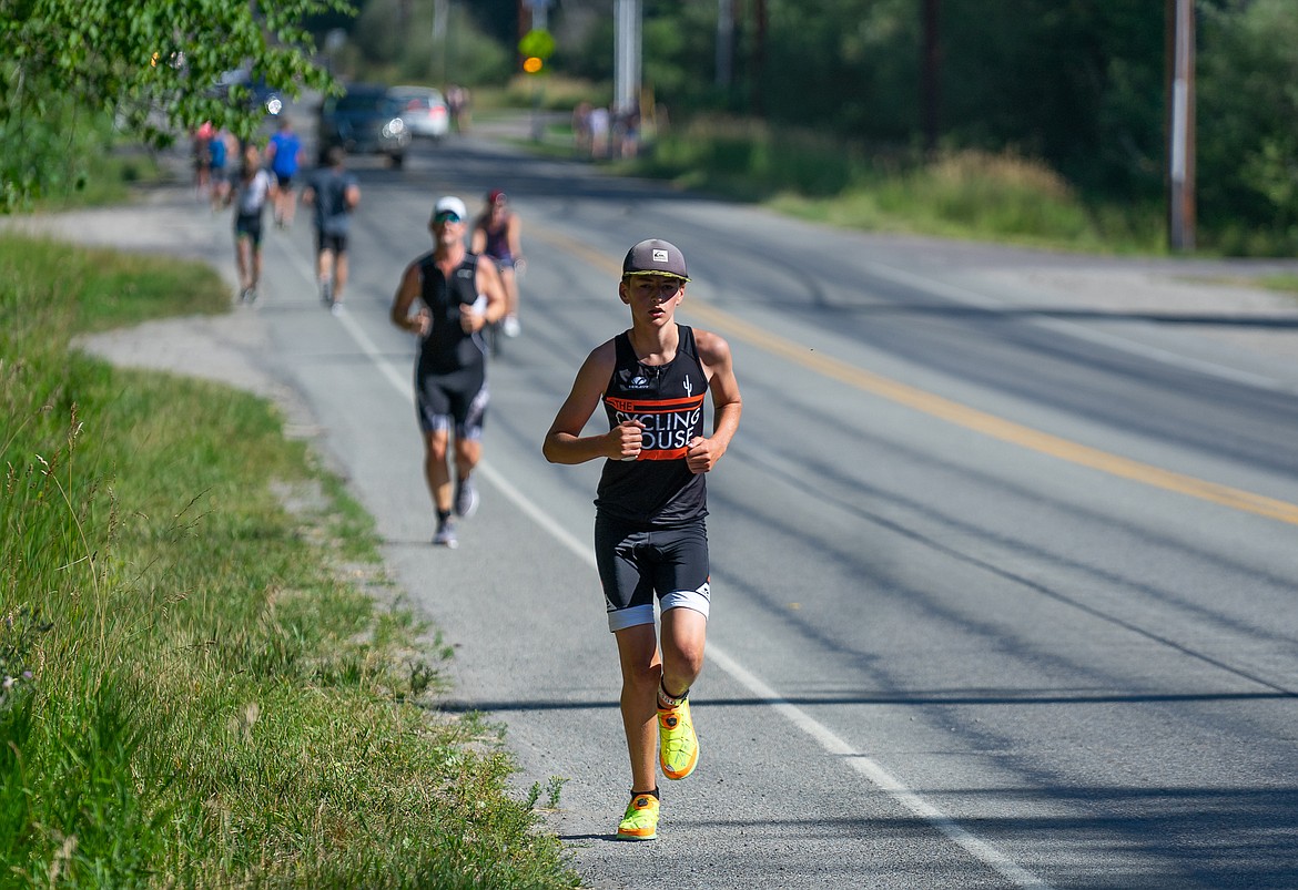 Whitefish's Landon Brown leads the pack coming down Wisconsin Avenue during the Whitefish Lake Triathlon on Sunday. (Daniel McKay/Whitefish Pilot)