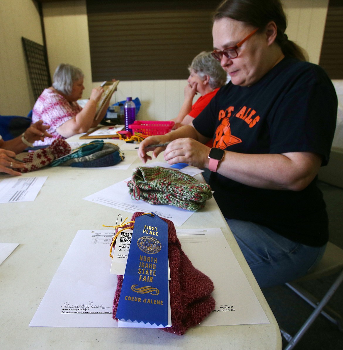 Kari Amos judges knitted socks Thursday at the Kootenai County Fairgrounds. A number of fine arts exhibits have gone up prior to the North Idaho State Fair, which opens Wednesday.