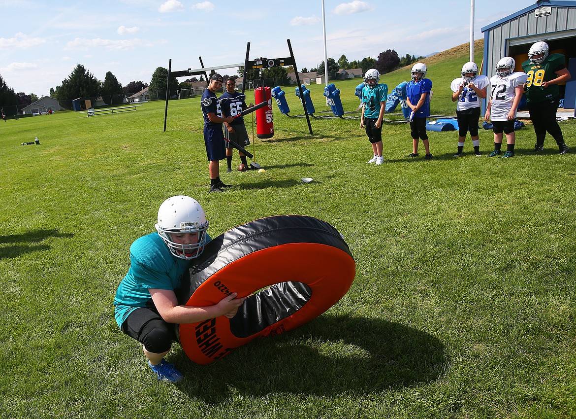 Isaiah Freeman, a seventh-grade student at Woodland Middle School, practices tackling at Lake City High School&#146;s Junior Tackle camp.