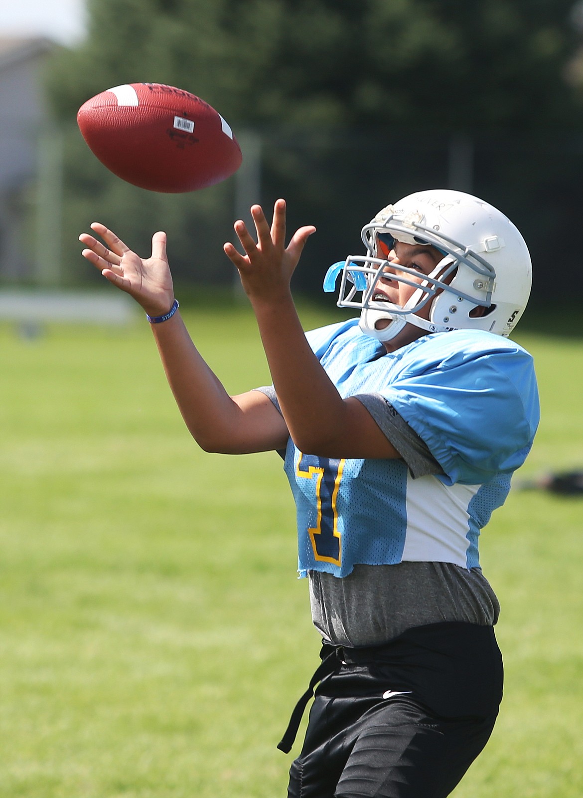 Jericho Shawver, a seventh-grade student at Coeur dAlene Charter Academy, catches a pass during wide receiver drills at Lake City High Schools Junior Tackle camp.